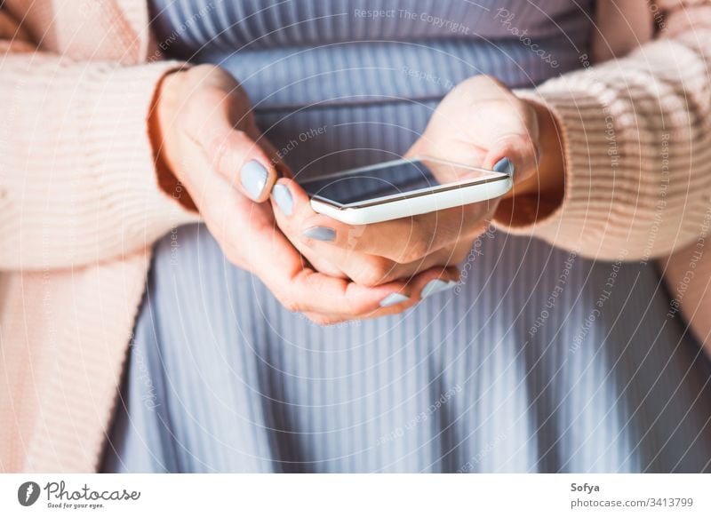 Woman using white smartphone. Pastel colors woman hands screen mobile pink violet device purple coral application website internet connection communication