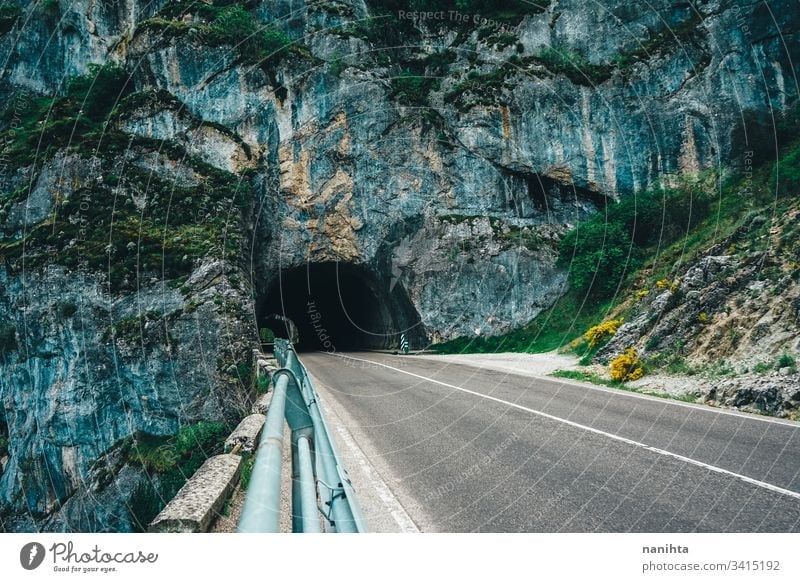 Natural bridge over an empty road natural mountain travel trip alone depth of field cave beautiful landscape wild nature outdoors cold cold tones risk road trip
