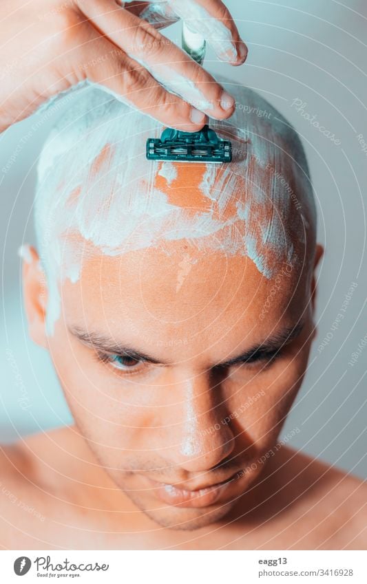 Man Shaving His Head Using White Foam appearance bald balding bath blade care concentration cropped depilation determination expressing eye face foam front guy