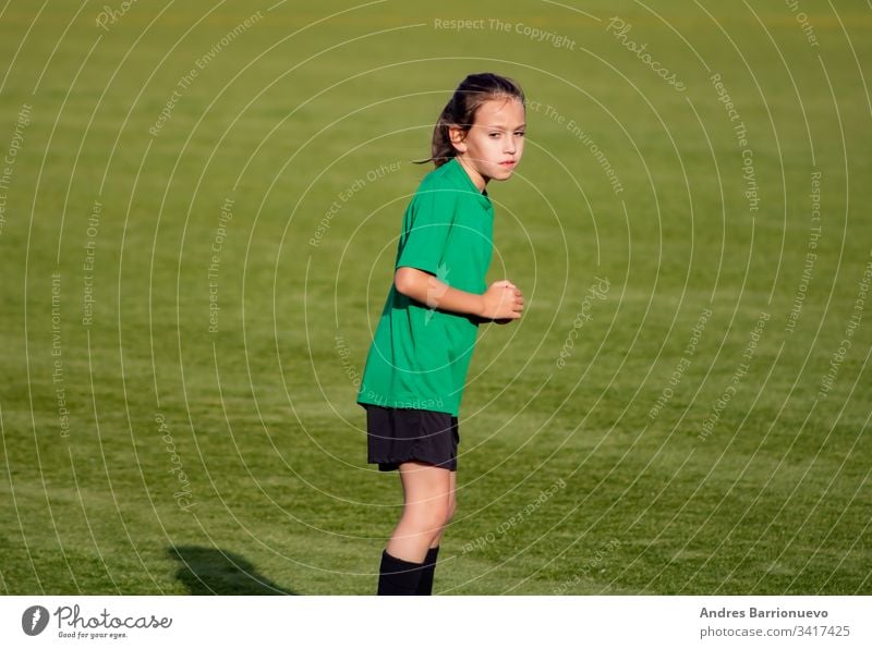 Little girl in a soccer training light beautiful cute game ball player girls kid practice tired female childhood youth exercise uniform little person sweat