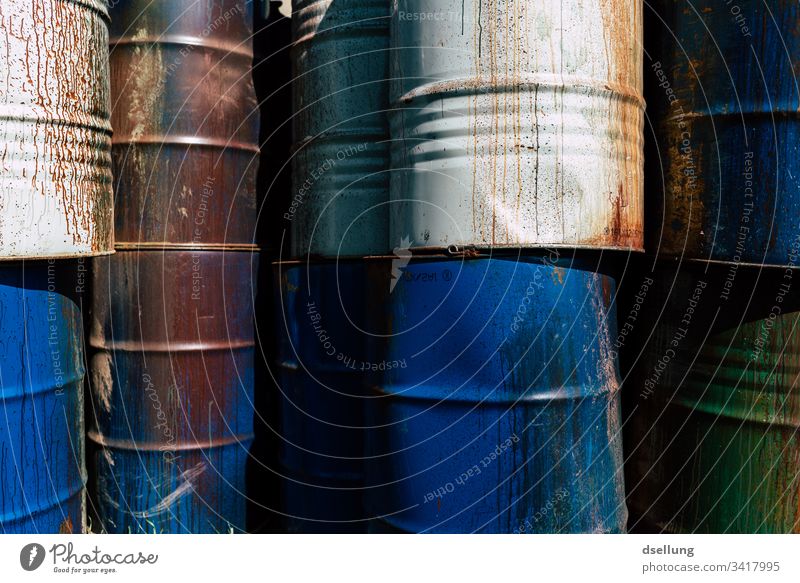 Different barrels stacked to a wall Threat Environmental damage Part Dry Background picture Environmental protection Damage Crack & Rip & Tear Bizarre Gloomy