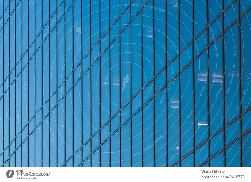 Glass facade of an office building windows architecture architectural architectonic urban metropolitan constructed edifice structure geometric geometrical
