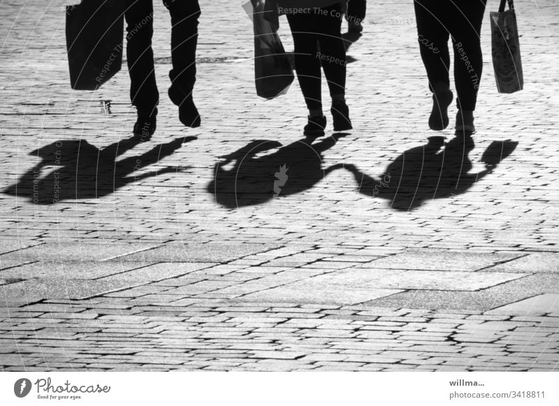 Shadow of a group of people - the lively threesome Group Family Legs Shopping shopping bag city stroll Shopping trip couple 3 Walking triple feet Human being