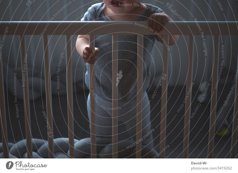 Child in crib is awake and crying Cot Alert cries screams Awakened Toddler Baby Crib Scream Cry Grating penned Emotions emotionally by oneself Lonely Fear shout