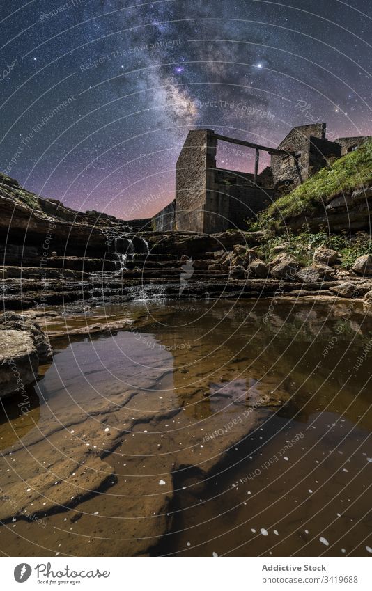 Old stone ruins on starry night landscape nature sky castle stair waterfall milky way stream rock ancient structure building old dark travel construction