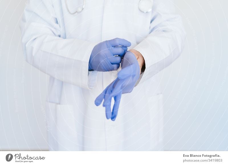 caucasian doctor using protective gloves. Chinese Corona virus concept portrait man professional corona virus hospital working infection wearing safety epidemic