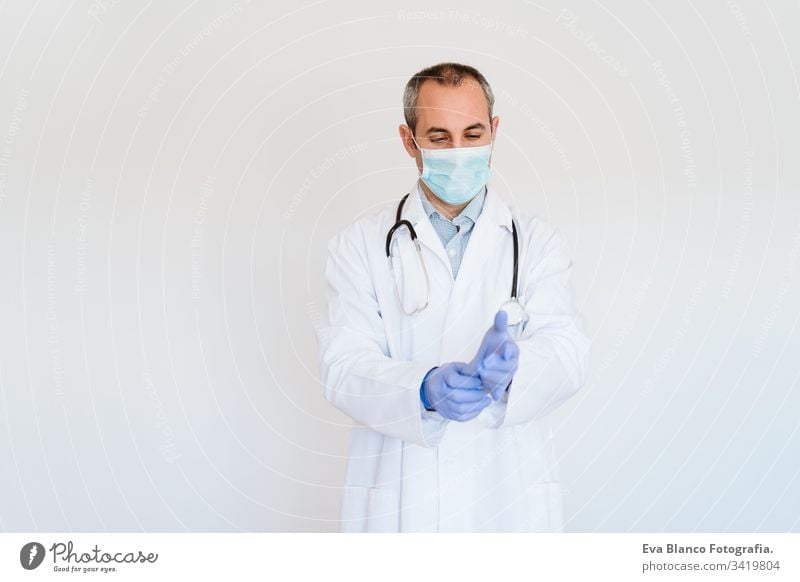 caucasian doctor using protective gloves. Chinese Corona virus concept portrait man professional corona virus hospital working infection wearing safety epidemic