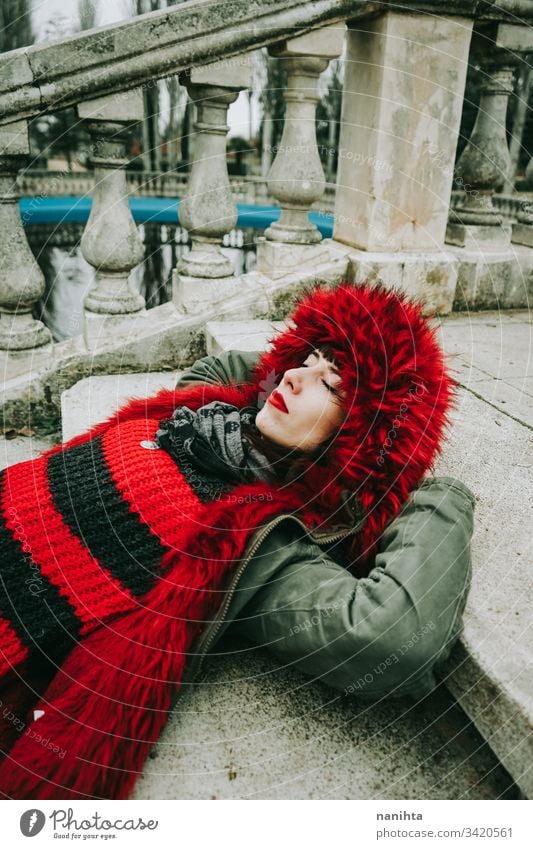 Young cool woman with ghotic style in an urban place city winter clothes goth rock modern casual wear trendy coolness fresh freshness youth outdoors park