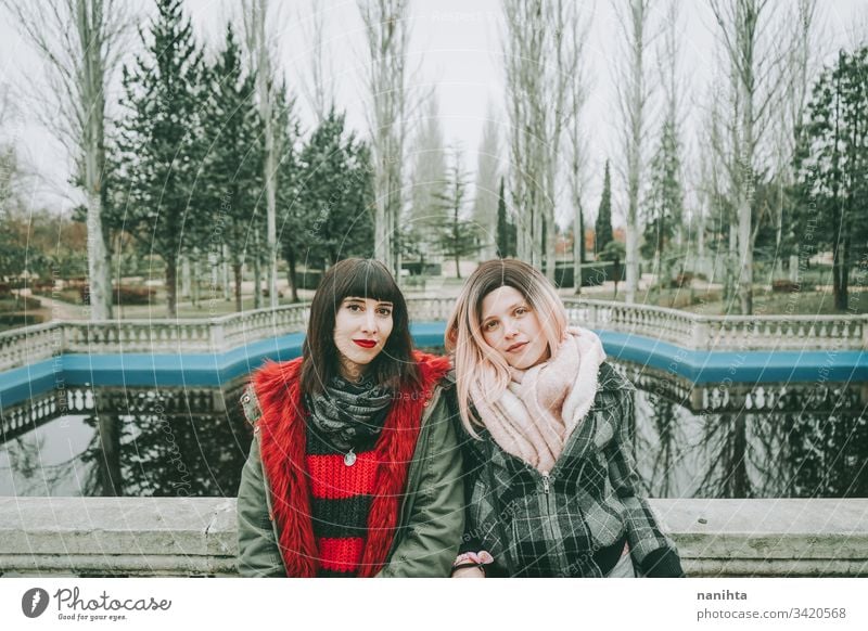 Two young and casual women spending time together friends trendy youth friendship two urban outdoors funny enjoy life lifestyle youthful fresh real candid