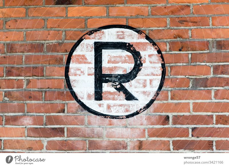 Large black R on white background on a brick wall Letters (alphabet) Colour photo Day Characters Exterior shot Capital letter sign Brick wall Building
