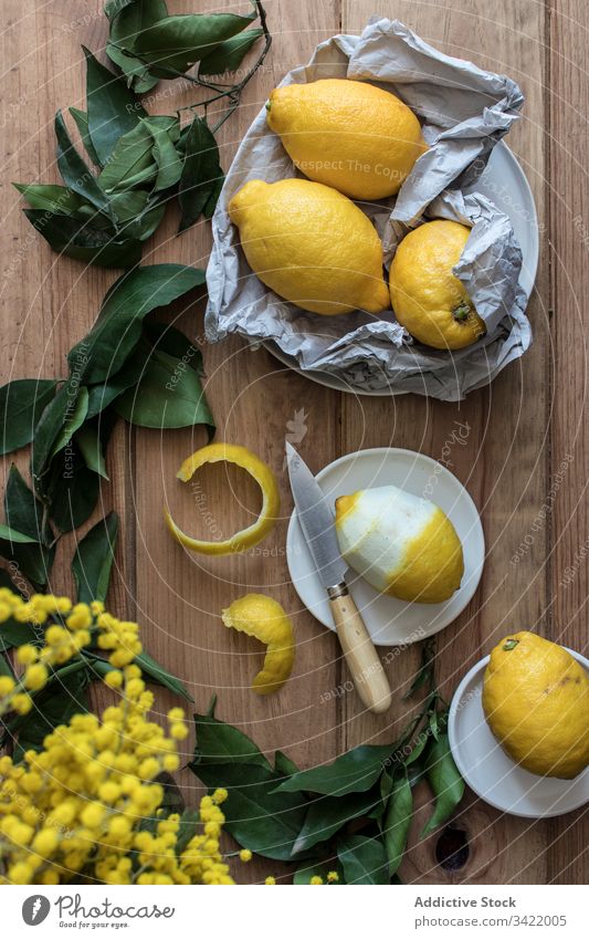 Composition of lemons and green leaves leaf peel fresh citrus food wooden organic healthy natural delicious table yellow raw juice sour rustic composition ripe