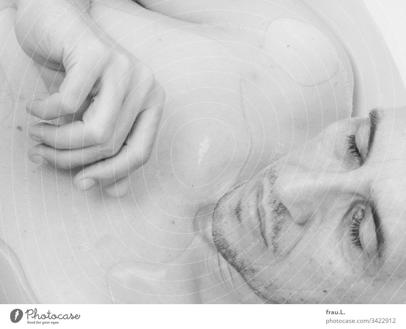 Gently the warm bath water embraced the sleeping man. Man bathe Sleep Head Face Hand Black & white photo Interior shot Dream Portrait photograph Calm