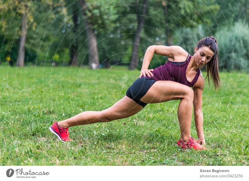 Young woman taking exercises in a park female summer outdoor training fitness grass forest green motion person exercising countryside attractive healthy