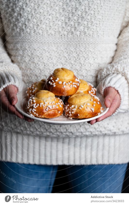 Woman holding plate with buns food bake homemade woman tasty pastry sweet yummy fresh nutrition appetizing eat cook culinary winter season tradition female