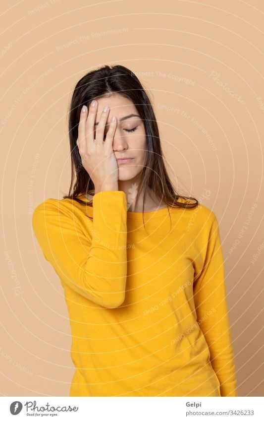 Attractive young girl wearing a yellow T-shirt person migraine discomfort headache problem worry sad worried fever energy negative stress unhappy expression