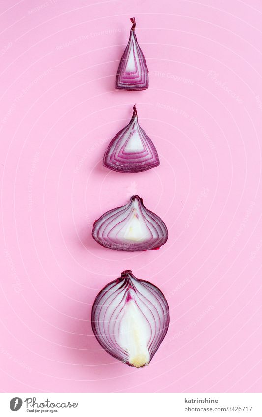 Purple onion on a light pink background purple red sliced half food healthy monochrome top view raw organic vegetable ingredient vegetarian ripe vitamin natural