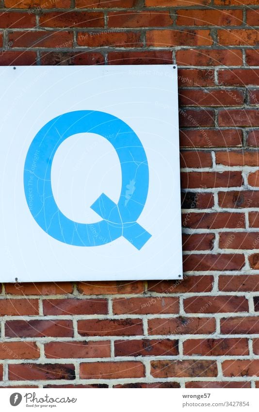 Blue Q on white board on a brick wall q Letters (alphabet) Colour photo Day Characters Exterior shot Capital letter Blackboard sign Brick wall Building