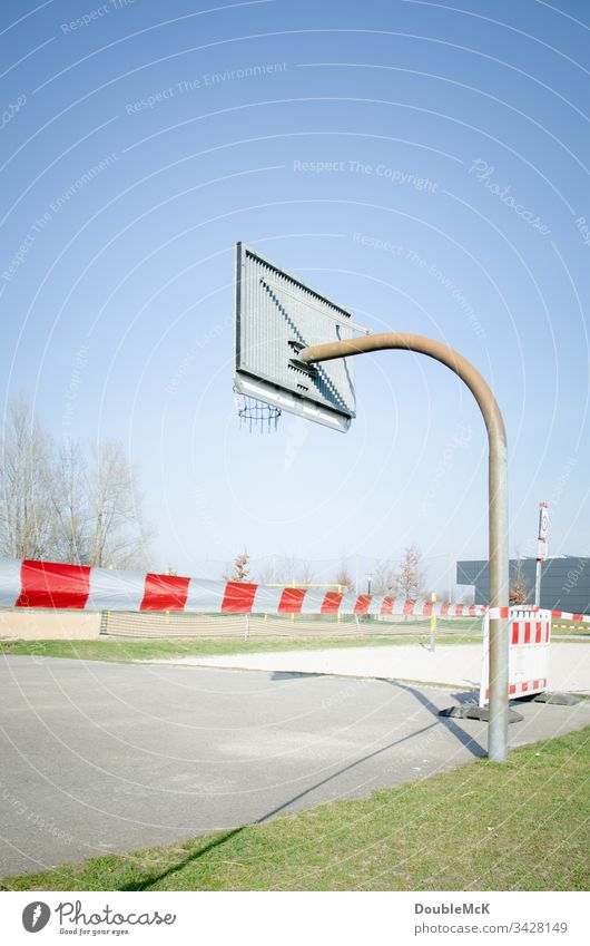 Playing prohibited - deserted basketball court closed due to coronavirus cordon barrier tape blocking Basketball arena Basketball basket Day Exterior shot