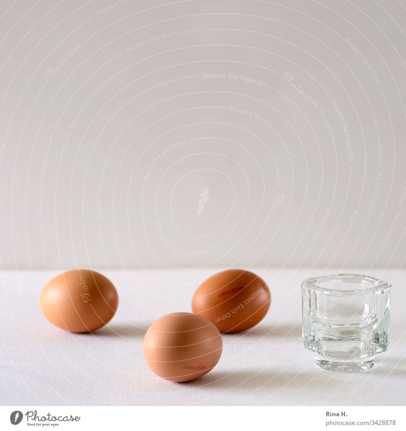 Three brown eggs and an egg cup Egg cup Easter minimalism Easter egg Breakfast Colour photo boiled eggs Food Interior shot Deserted