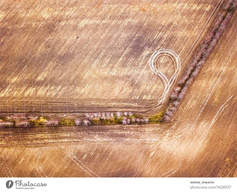 Empty plowed field in early spring, top aerial view. Panorama empty agriculture cultivated scene rural industrial sunny outdoor sunlight outdoors village