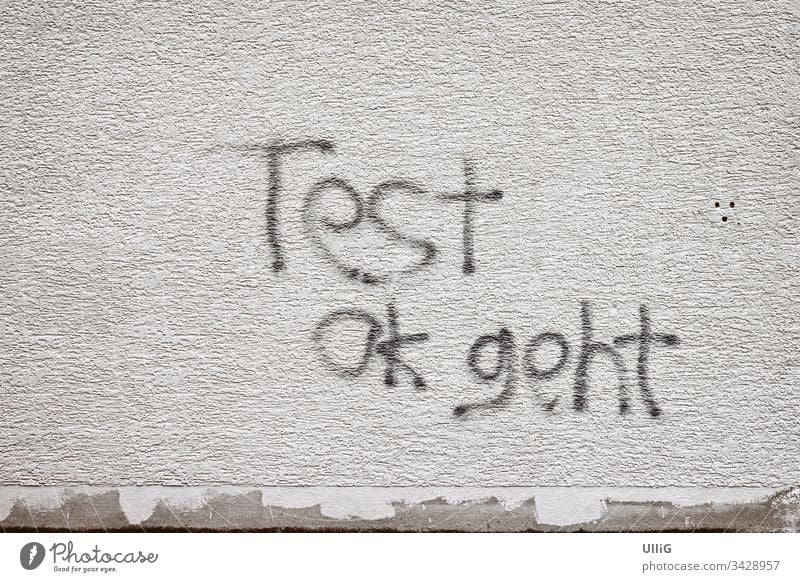 Test Ok Geht - Graffiti on a house wall. test graffiti writing Text embassy Message Daub Vandalism Grafitto Surface letterings Sign symbol Grease text art