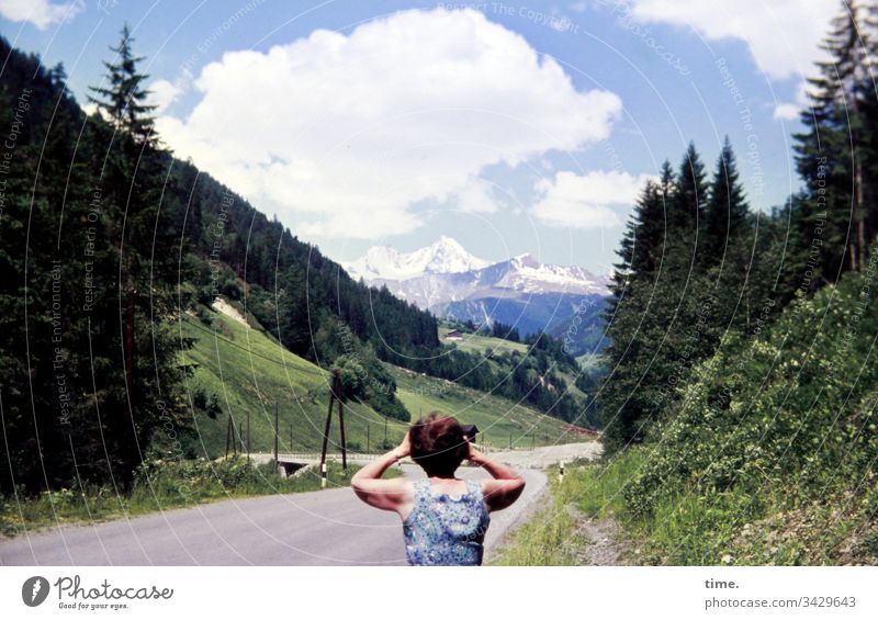 watch out | climate change vacation travel see Observe mountains Street Sky Woman Clouds Snow snow-covered Idyll Binoculars Dress Summer Forest Rear view Back