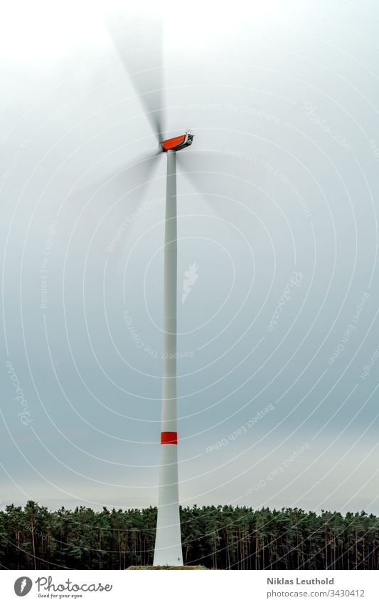 Rotating wind turbine Pinwheel Wind Wind energy plant Energy industry Renewable energy Environment Environmental protection motion blur Movement Rotation Rotate