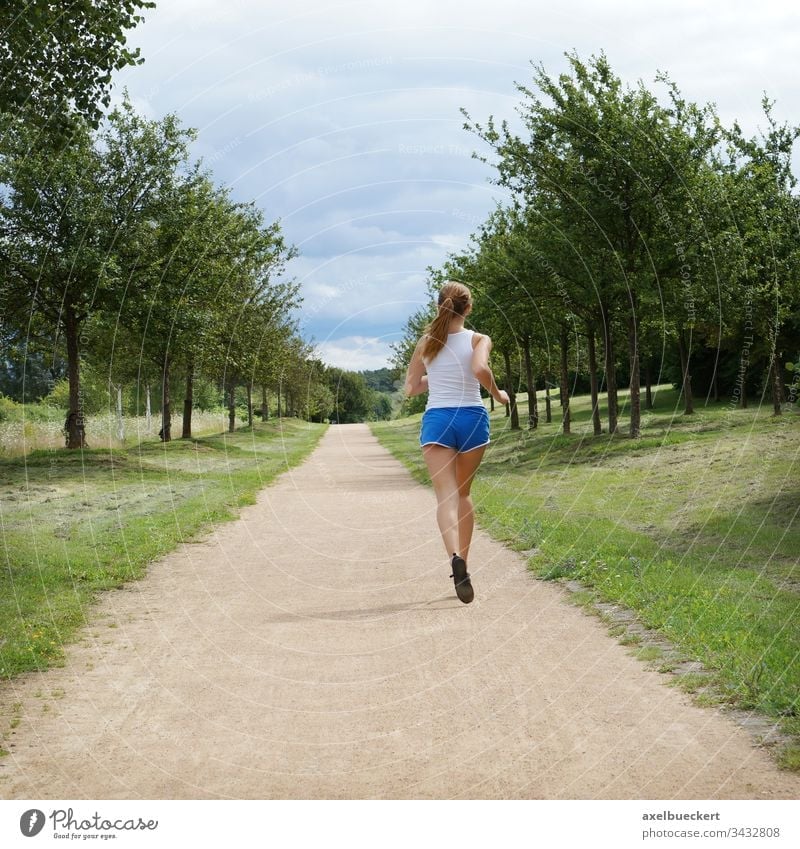young woman jogging alone Jogging Running Woman Girl Jogger Sports Nature Sportswear Fitness Healthy Park youthful person Caucasian Lifestyle Outdoors