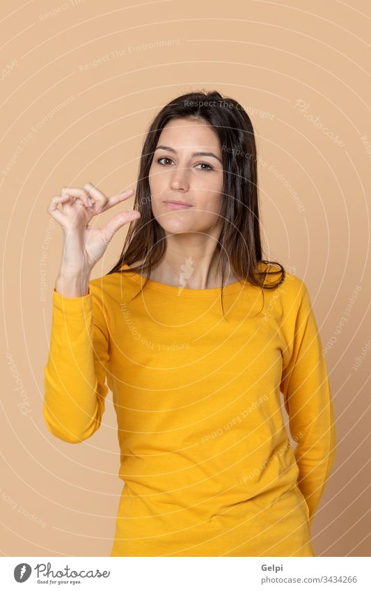 Attractive young girl wearing a yellow T-shirt person bit little illness indicate indicating finger advertisement copy space expression gesture beautiful female