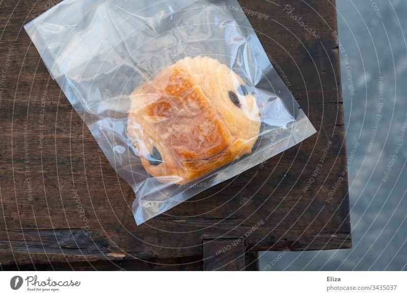 A chocolate croissant or Pain au Chocolat which is shrink-wrapped in plastic pain au chocolat Packaging Chocolate Crossaint pastry hygienic Trash