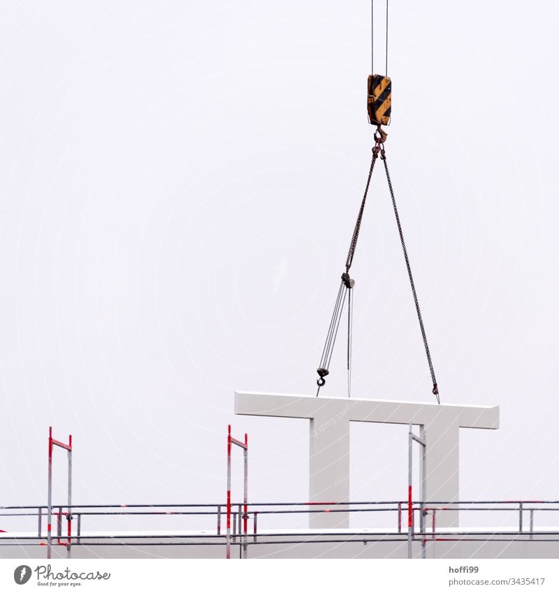 Suspended concrete elements on the load hook of a crane Construction site Crane ladder construction site supply Work and employment Craft (trade) Build