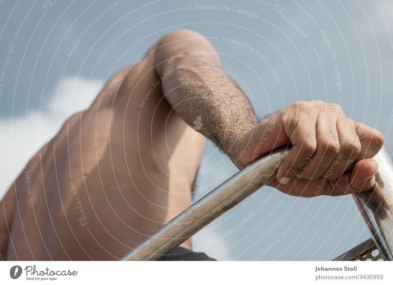 Male hand and upper body in front of a blue sky Hand arm Sand sandy Beach Lifeguard Lifesavers be afloat bathe Observe Sky Chair Chrome Hunting Blind lookout