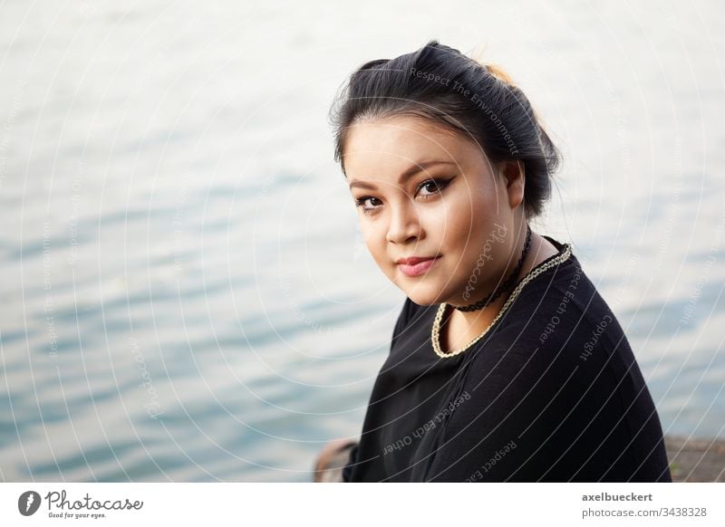 Young Asian Woman By The Water A Royalty Free Stock Photo From Photocase