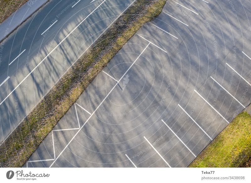 Empty parking lot from above cars car parking lines concrete tree trees white grey street traffic city