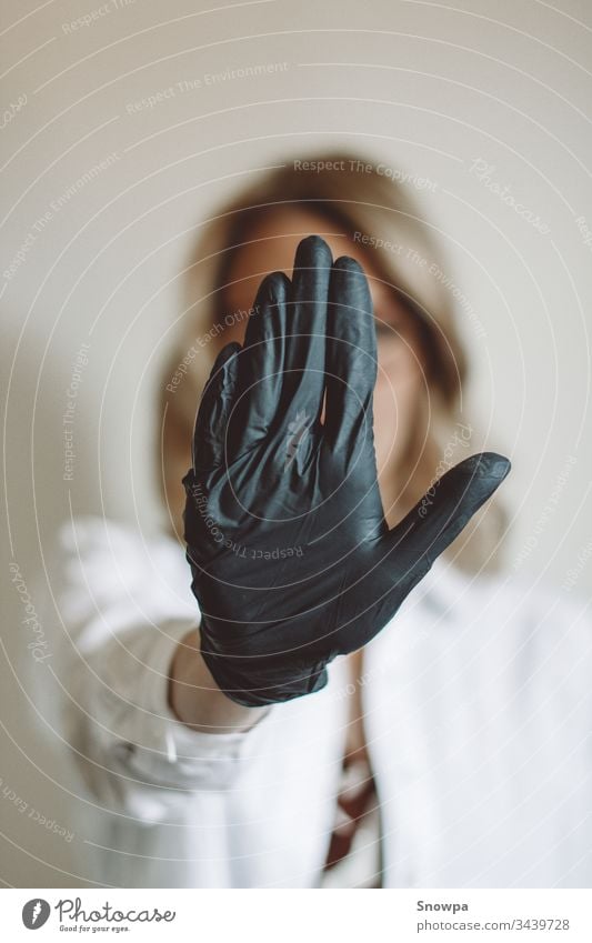 Woman Showing Stop Sign with Black Glove on glove Gloves black gloves rubber glove Doctor Scientist Blonde blond hair scrub covid-19 coronavirus Virus attention