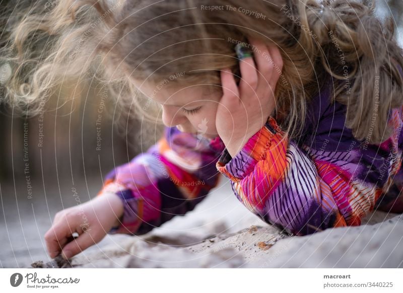 Child playing in the sand Sand Playing Boredom bore Schoolchild girl corona virus Virus covid19 sars Close-up sandy Beach holidays school closures Closed kita