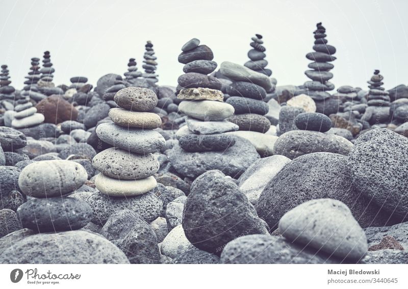Stone stacks on a beach. stone pebble pile pyramid nature peaceful instagram effect filtered volcanic equilibrium balance rock nobody zen calm concept