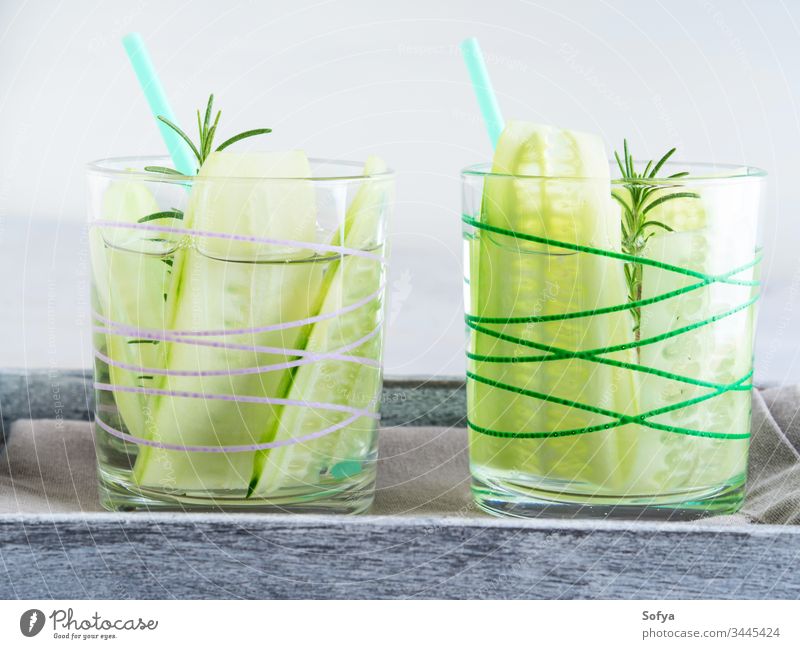 Infused water with cucumber and rosemary detox infused infusion herb healthy diet drink simple recipe blue glass straw food green concept serve two