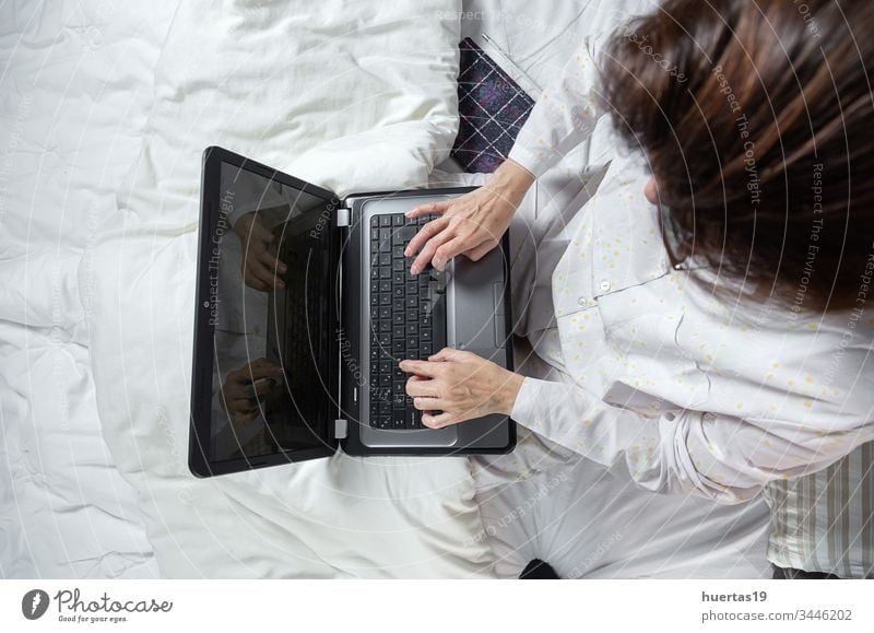 Adult woman working at home in pijama laptop technology computer people person lap top adult female business lifestyle businesswoman glasses caucasian indoors