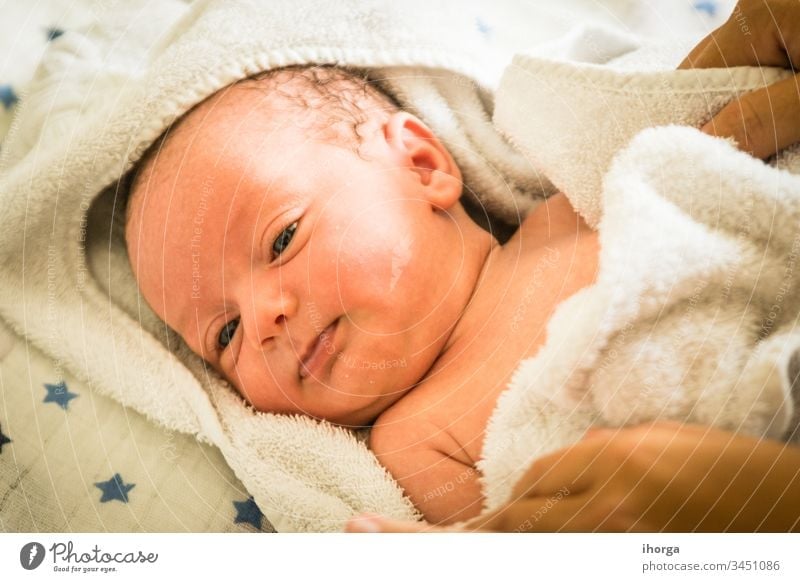 newborn baby at the time of his bath adorable beautiful blanket boy care caucasian cheerful child childhood clean closeup comfortable cute emotion expression