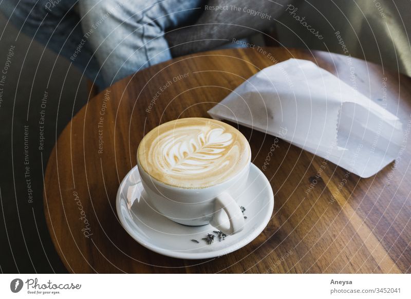 A latte and pastry on a table 2017-2020 first import latte art coffee coffee shop coffee cup Coffee break meeting date bistro pastry bag Latte macchiato Cup