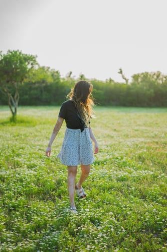 A young woman walking in a field of little flowers 2017-2020 first import girl elegant free spirit Youth (Young adults) Human being Feminine Style Beautiful
