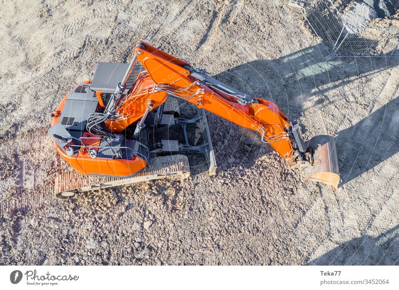 Oranger Bagger from above Excavator Construction site Work and employment white job Construction worker