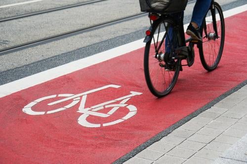 designated bike lane or cycle highway bicycle path cyclist cycling cycleway track traffic street red city symbol biking travel commute asphalt safety person