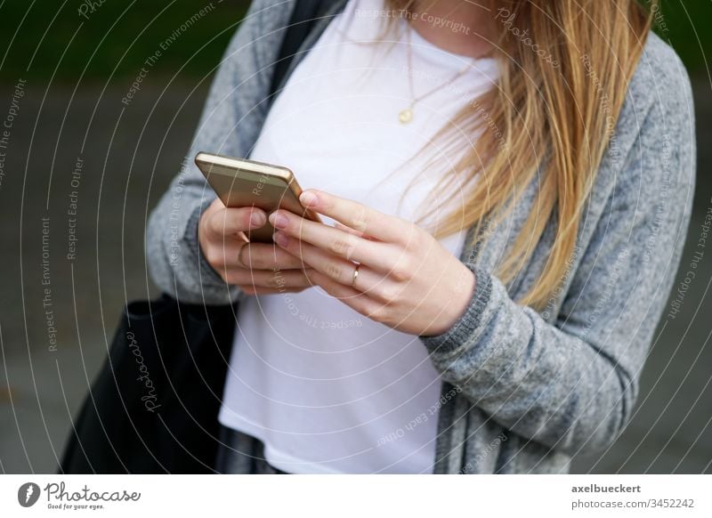 young woman using smartphone mobile smart phone cellphone girl female internet person real people technology communication lifestyle hand holding text message