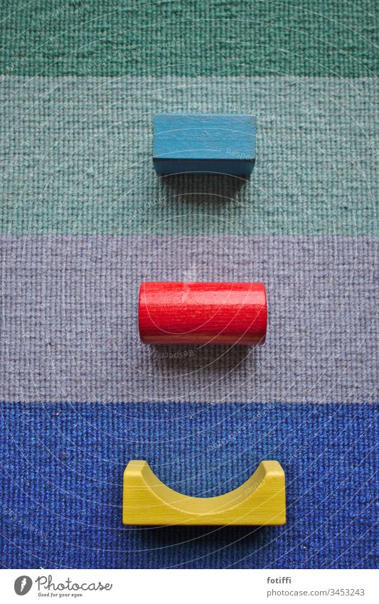 Friendly building block cyclops | Wooden building blocks on a striped carpet variegated Toy building bricks Carpet Striped Deserted Pattern