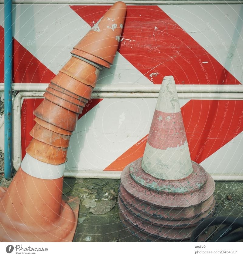 hat game Road traffic sign Road sign Traffic Cone Skittle Hats Red White Reddish white Stack Many Old worn-out Ravages of time depot Colour photo Deserted