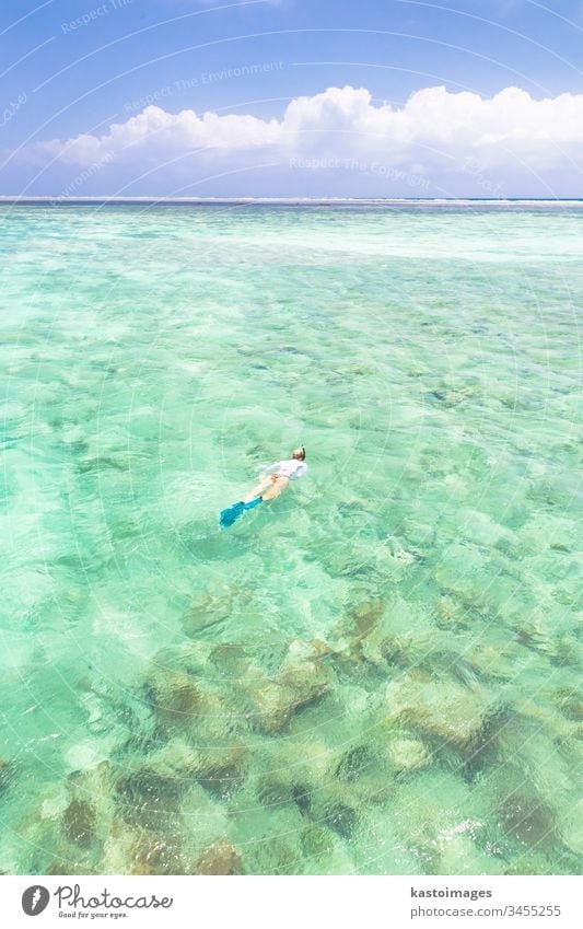 woman snorkeling in turquoise blue sea. Zanzibar Mnemba tropical beach water ocean vacation mask outdoor nature travel island people leisure holiday female
