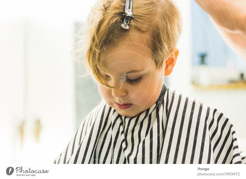 the little boy in a hairdressing salon adorable baby barber barbershop beauty blond care caucasian chair child childhood children comb cut cute face fashion