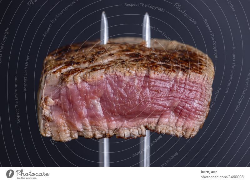 grilled steak on a meat fork close-up Cutlery sirloin steak Frying background White Red Eating roasted Juicy Quality Dinner Barbecue (apparatus) slice Meal BBQ